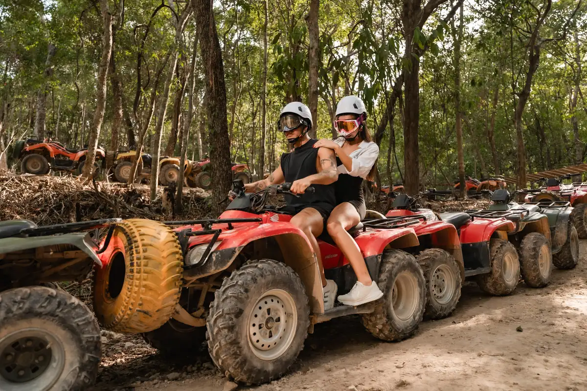 Couples lined up on ATVs ready to start a jungle tour