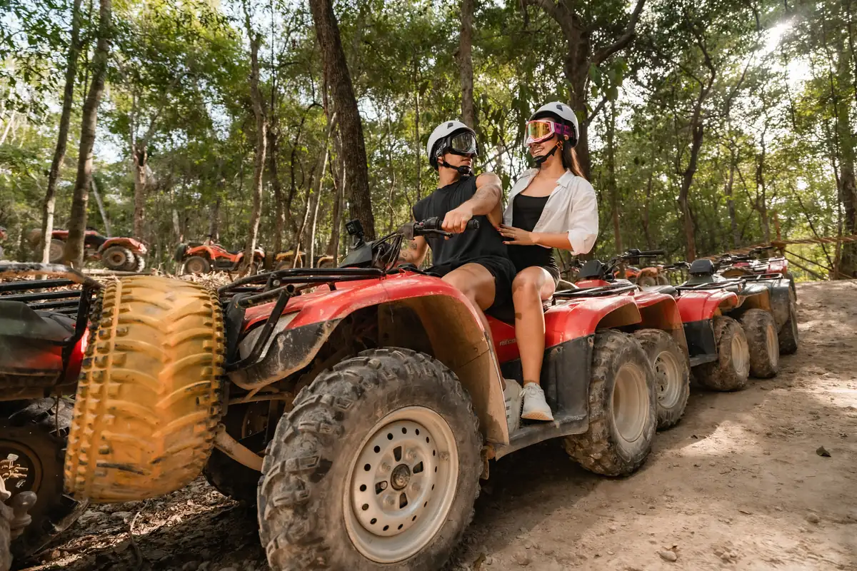 Couple sitting on an ATV ready for a private jungle tour