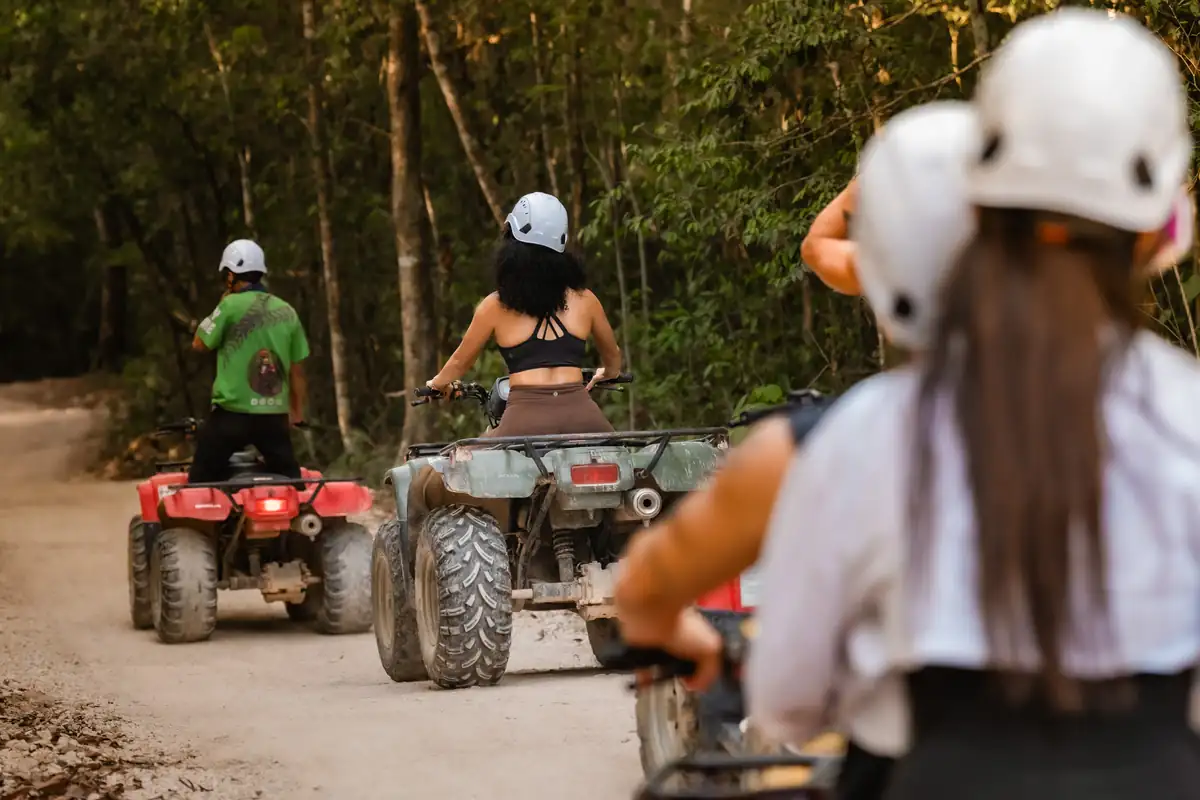 Group on ATVs following a guide through the jungle