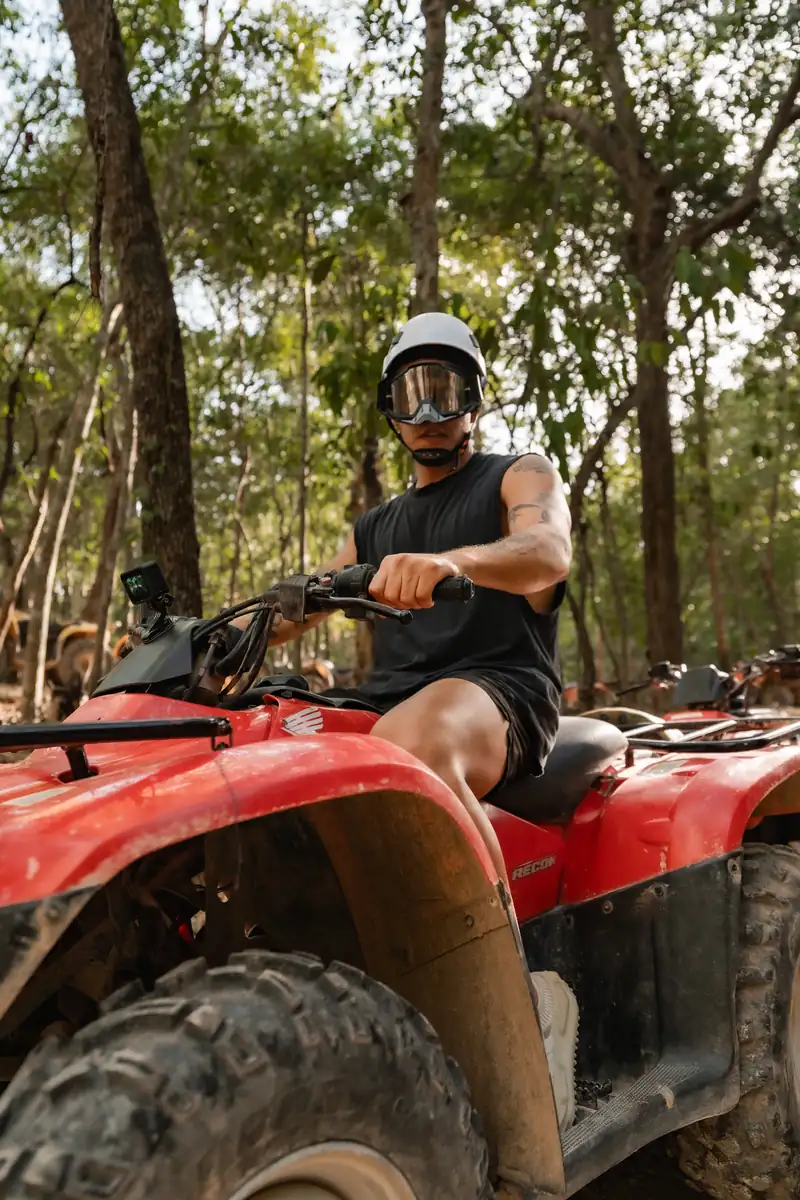 Rider wearing a helmet and goggles on an ATV
